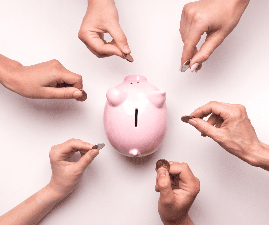 hands adding coins to a piggy bank